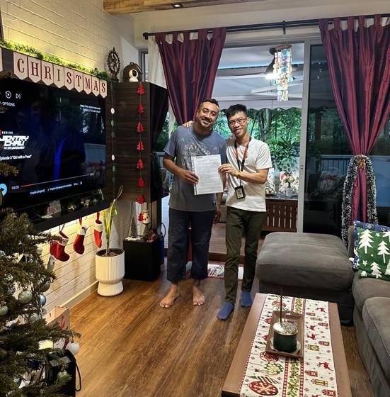 Wilfred with a client in his renovated living room at Christmas
