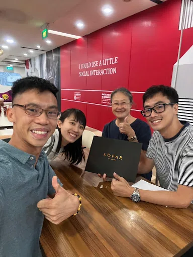 Wilfred with Van and family, documents folder in hand after the appointment